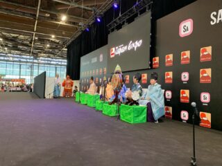 Japan Expo paris 3日目の様子✨
皆さま、投稿ご覧くださり誠にありがとうございます😊
準備を終えいよいよ本番日を迎えましたが、始まってみたらなかなかハードな日々💦
会場は9時〜18時までオープンしており、朝8時にホテルを出発、休みなく一日中演奏と体験を終え、渋滞の中ホテルに着くのは20時、そこから夕食、翌日準備など動き詰めの日々となったEXPO(笑)
始まってからはなかなかアップ出来なかったので、報告していきます🙇♂️
3日目オープンし、初日は1ステージと体験ブース。
1,000人が収容されるSAKURAステージで舞楽 還城楽を上演しました。
ありがたい事に、客席は満員🈵
興味の目と温かい拍手に迎えてもらいました。
JAPAN EXPOだけあって、舞台スタッフは日本人と現地のフランス人の方が担当。柔軟にご対応いただきました。ただ、広い会場でマイクを使用する為、雅楽の楽器の音量のバランスや配置を伝えるのが難しく、思い切った演奏が出来なかった日でもありました。
今回の EXPOは初日から動員が多かったらしく、
体験ブースでは雅楽を目当てに来場した着物の現地女性が、オープン後直ぐに体験ブースへ。
英語で「あなたに会うために来ました」と嬉しい言葉も😃
演奏終了後には、フランス将棋連盟のお手伝いをしている方や、毎朝雅楽を聴いているという古武道を習っている男性(毎日ブースに来てくれました 笑)など、たくさんの日本好きな方がお越しくださいました!
初日は勝手が分からず、右往左往する場面もありましたが、現地のコアなファンの方々と交流できた日となりました!